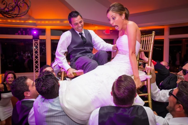 Bride and groom lifted on chairs during a high-energy Rhode Island wedding reception with DJ Bob Carpenter